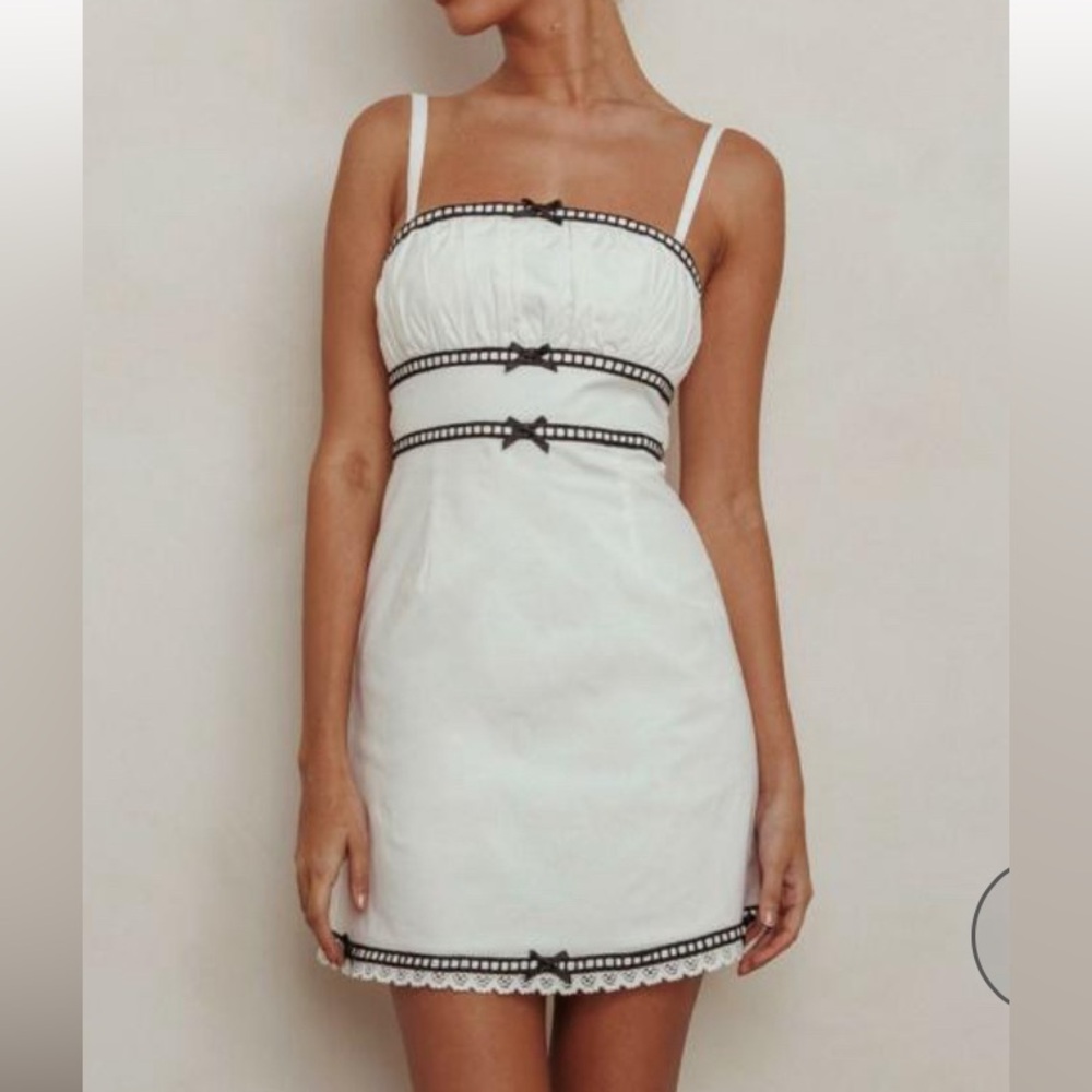 White Dress with Black bow ties.
